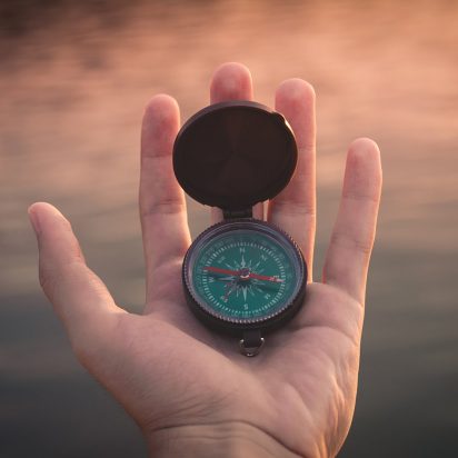 open compass in a hand